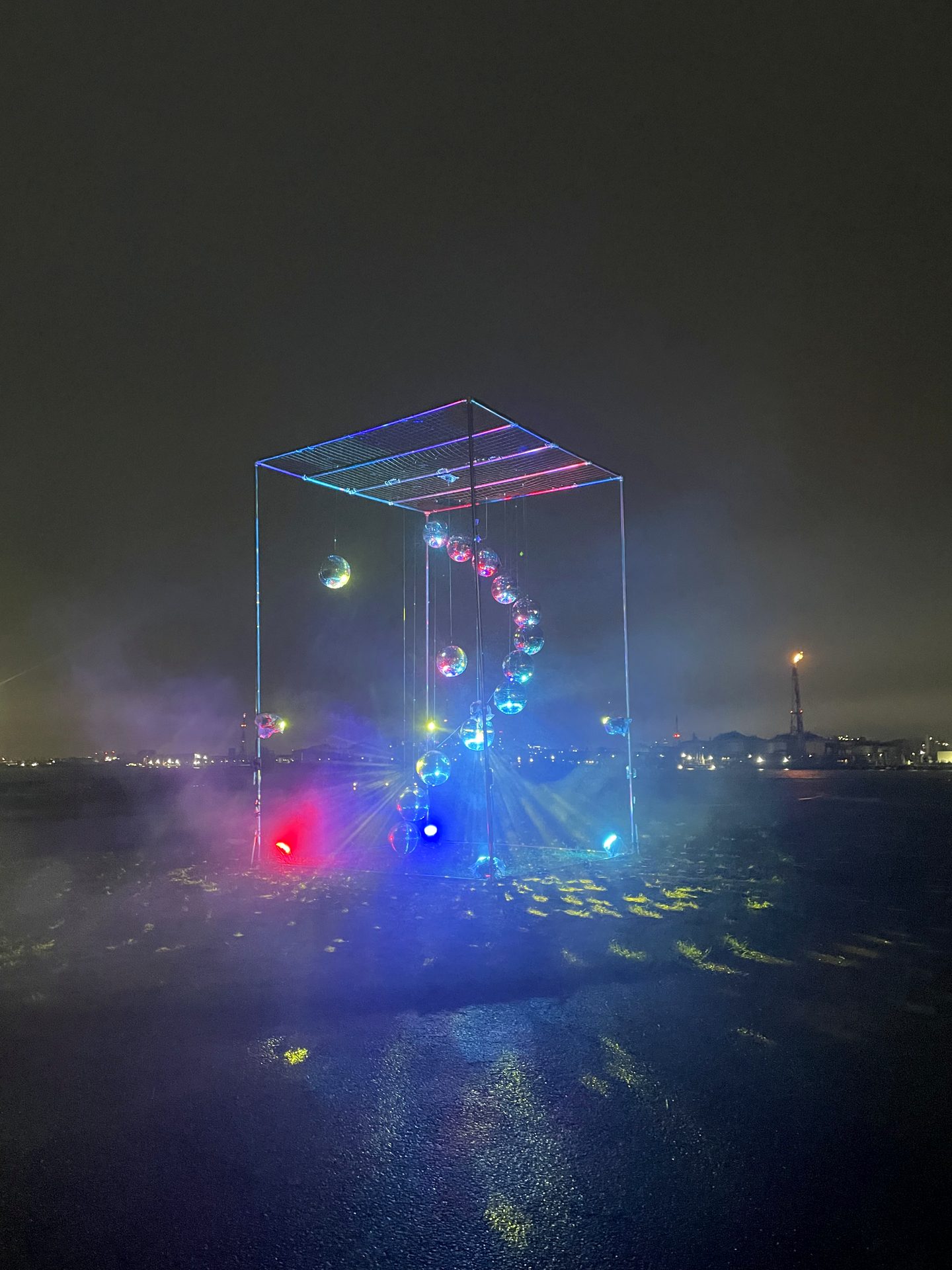 Mirrorball cube installation at dusk