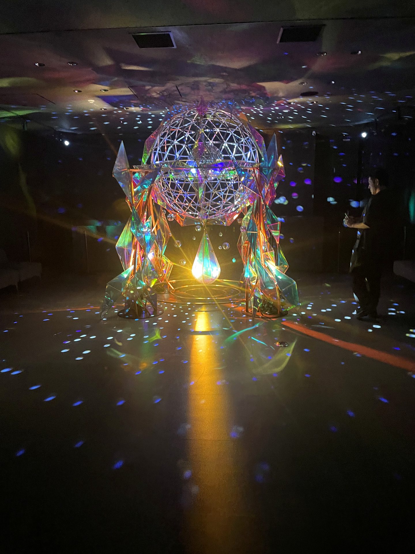 Mirrorball sculpture filling the hall with light