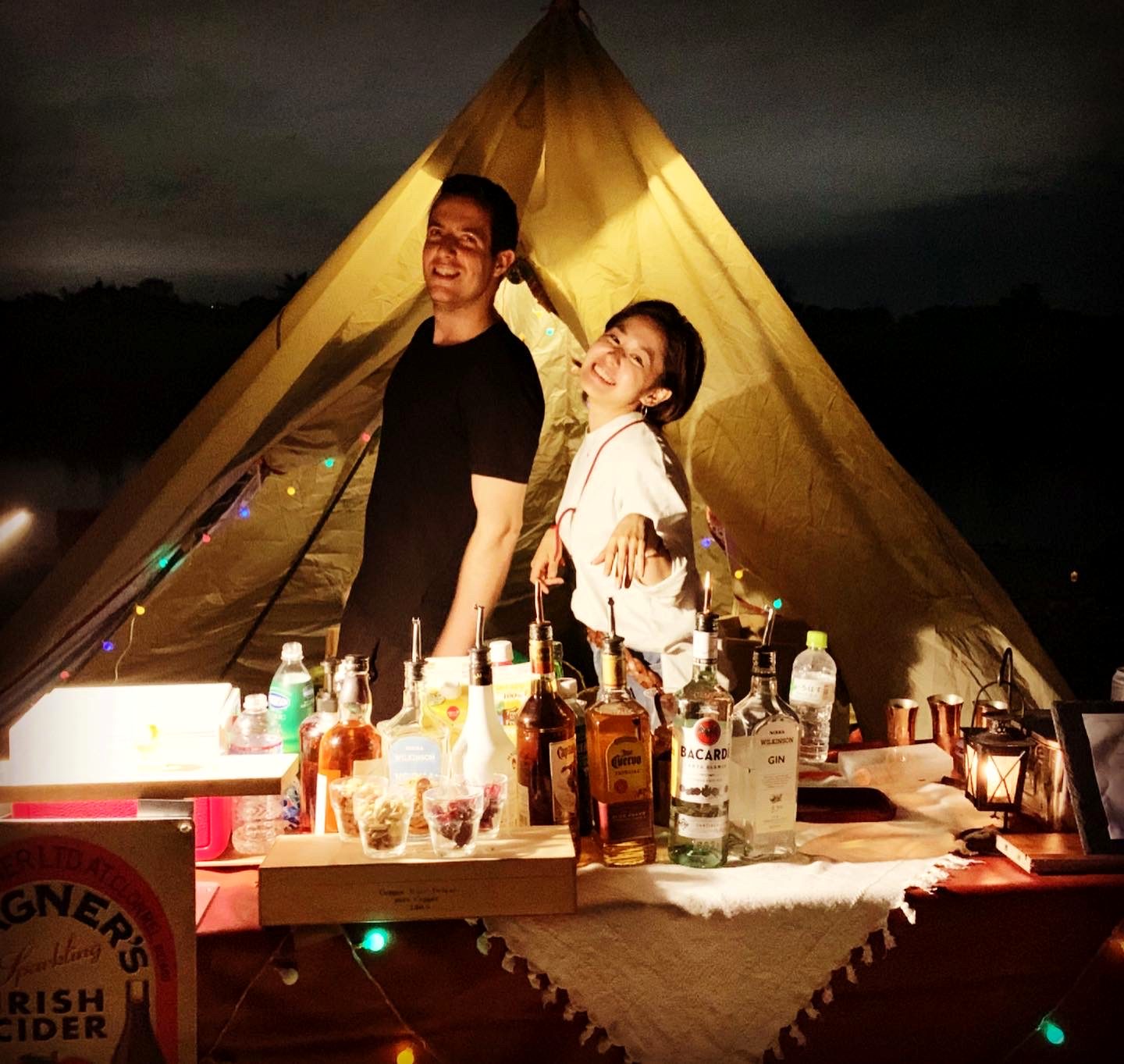 The LiQUiD tent bar glowing at night